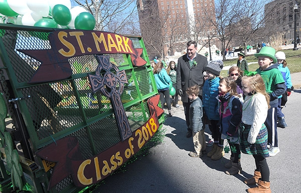 St Mark School father Peter Kooshoian, stands with his children and fellow students during City of Buffalo Annual St. Patrick's Day Parade on Delaware Avenue. Kooshoian has three children at the North Buffalo school. (Dan Cappellazzo/Staff Photographer)